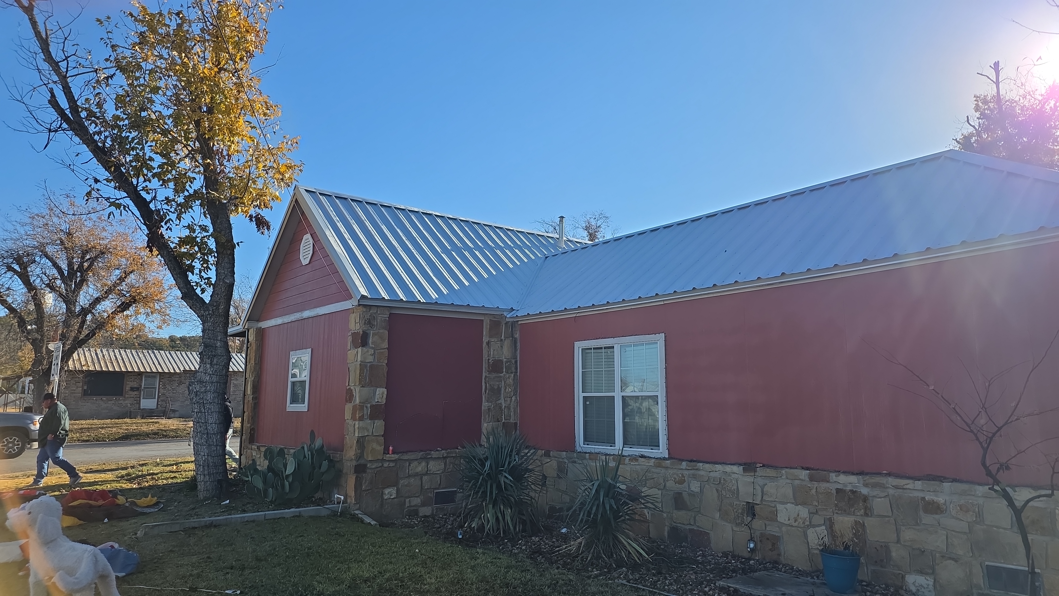 Side angle of metal roof on red home