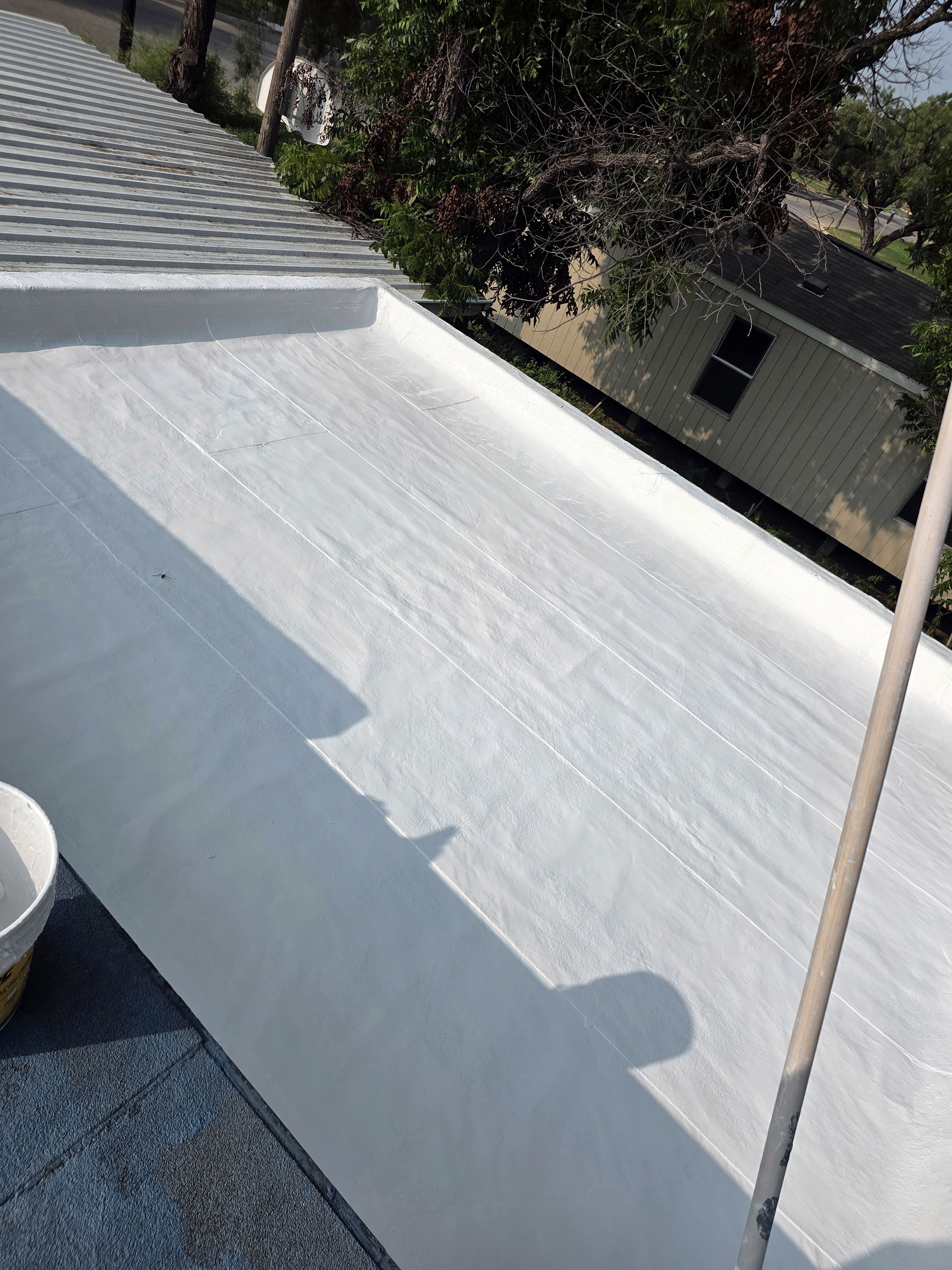 Commercial roof after white coating